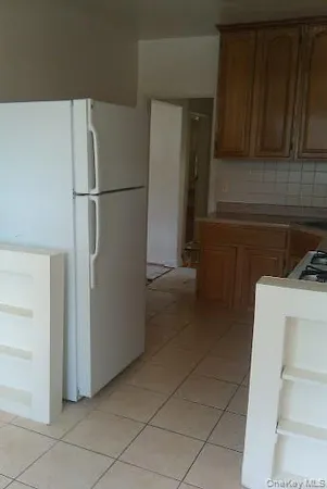 a kitchen with a refrigerator and cabinets