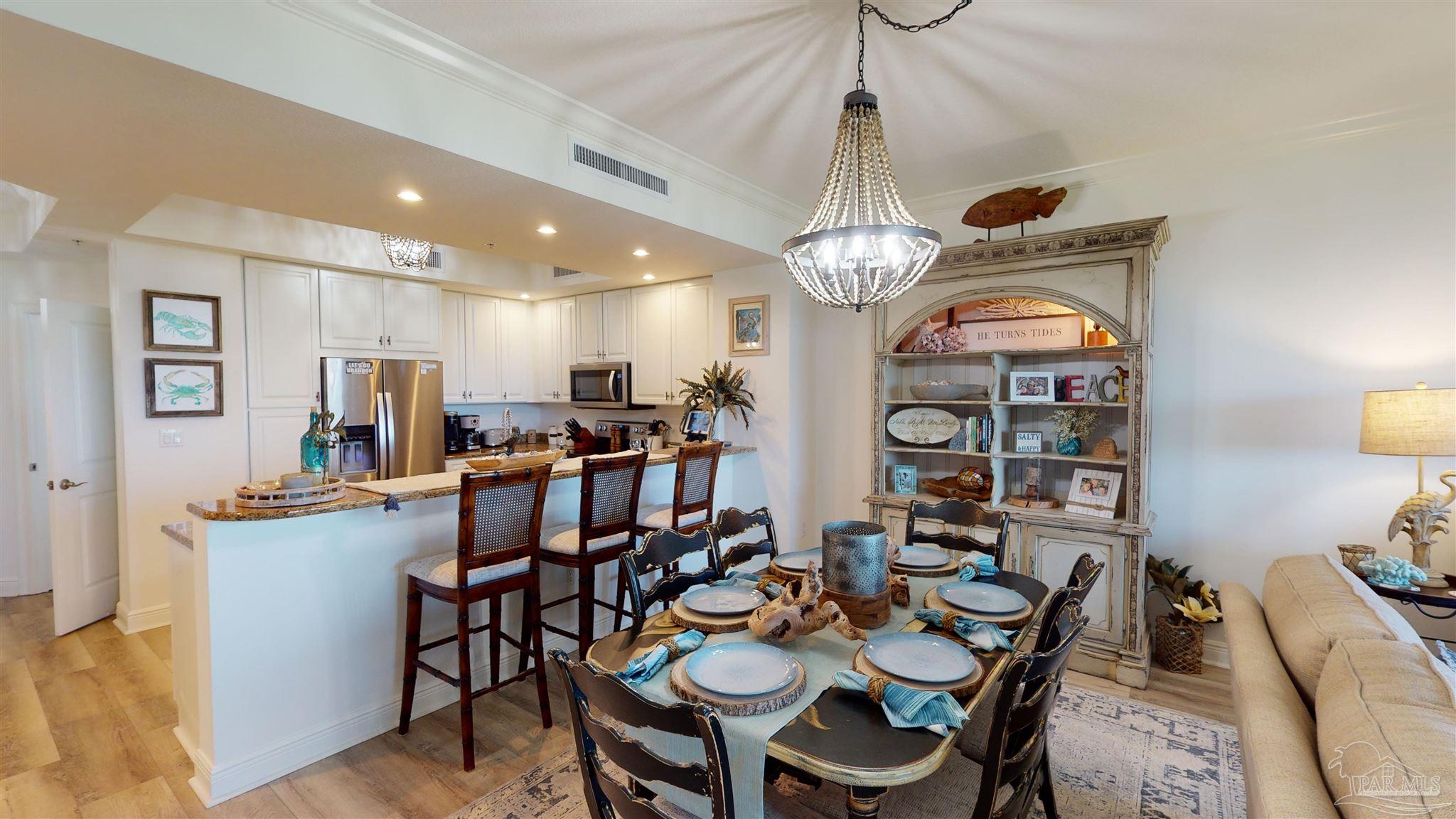 608 Lost Key Drive, Unit 404C Perdido Key, FL 32507 - Photo 2 of 28 a view of a dining room with furniture and a chandelier
