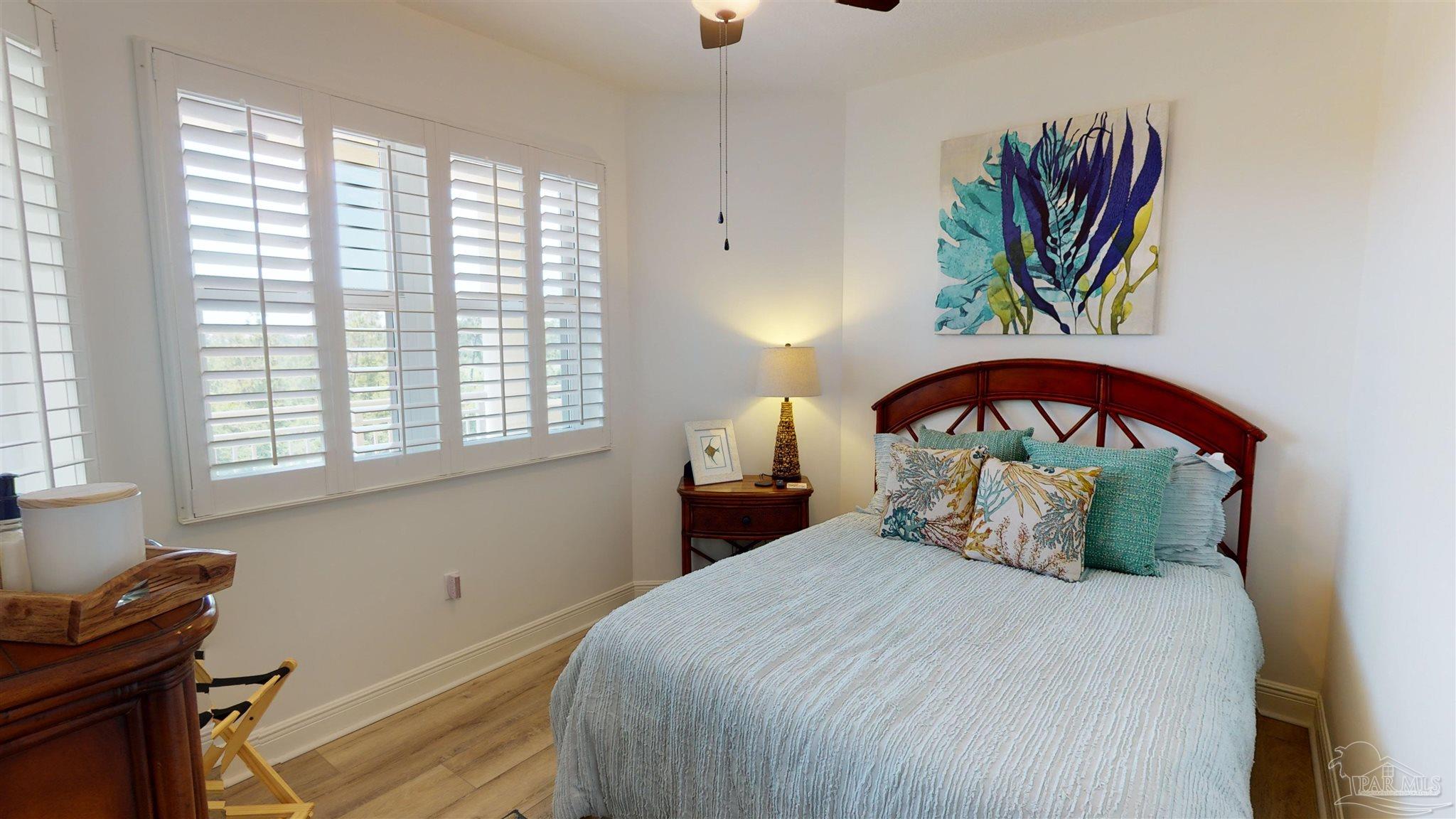 608 Lost Key Drive, Unit 404C Perdido Key, FL 32507 - Photo 23 of 28 a bedroom with a bed a dresser and a window