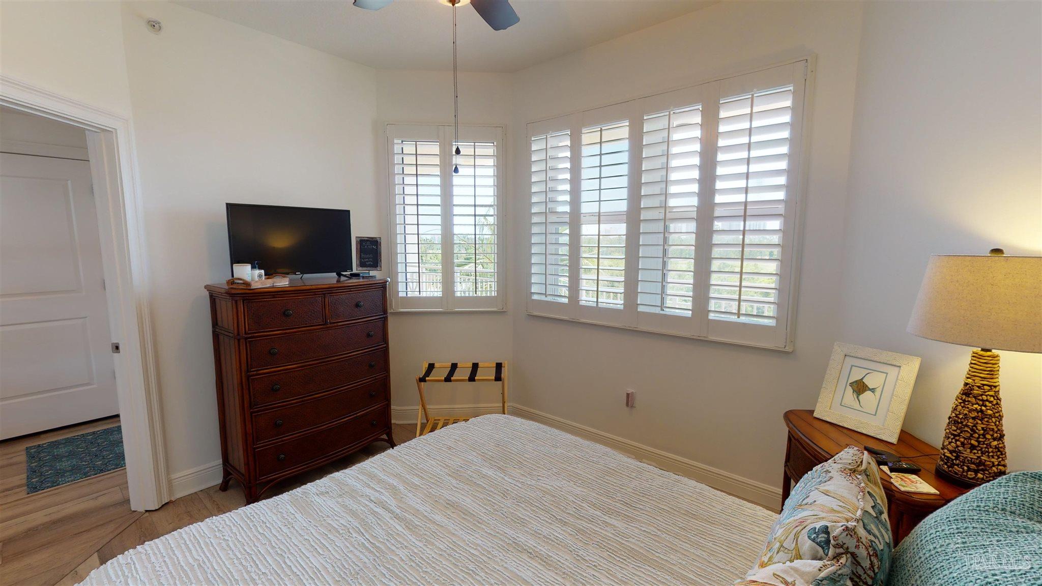608 Lost Key Drive, Unit 404C Perdido Key, FL 32507 - Photo 24 of 28 a bedroom with a bed and flat screen tv