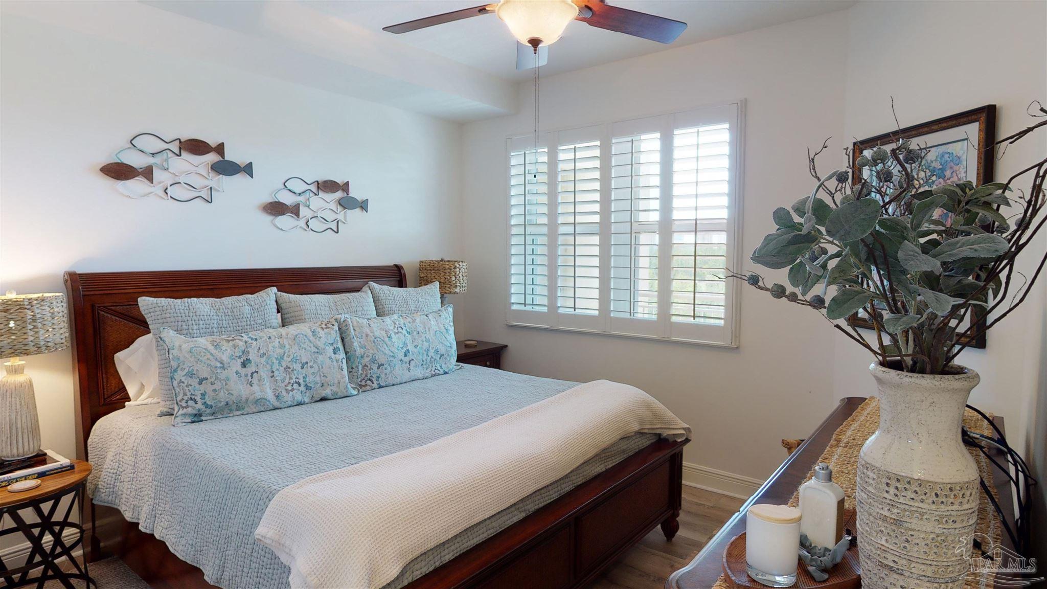 608 Lost Key Drive, Unit 404C Perdido Key, FL 32507 - Photo 25 of 28 a bedroom with a bed and a painting on the wall