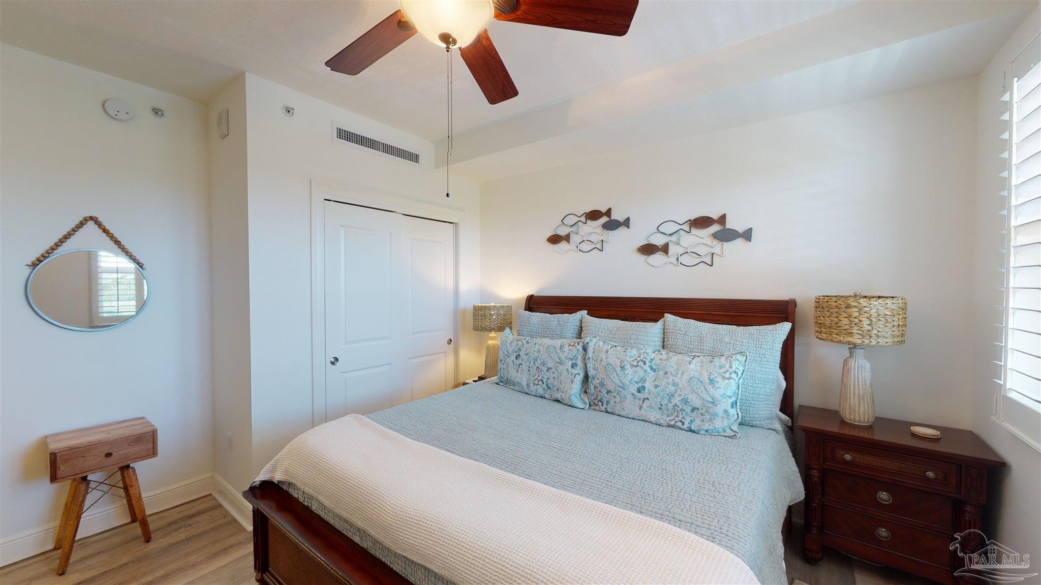 608 Lost Key Drive, Unit 404C Perdido Key, FL 32507 - Photo 26 of 28 a bedroom with a bed and wooden floor