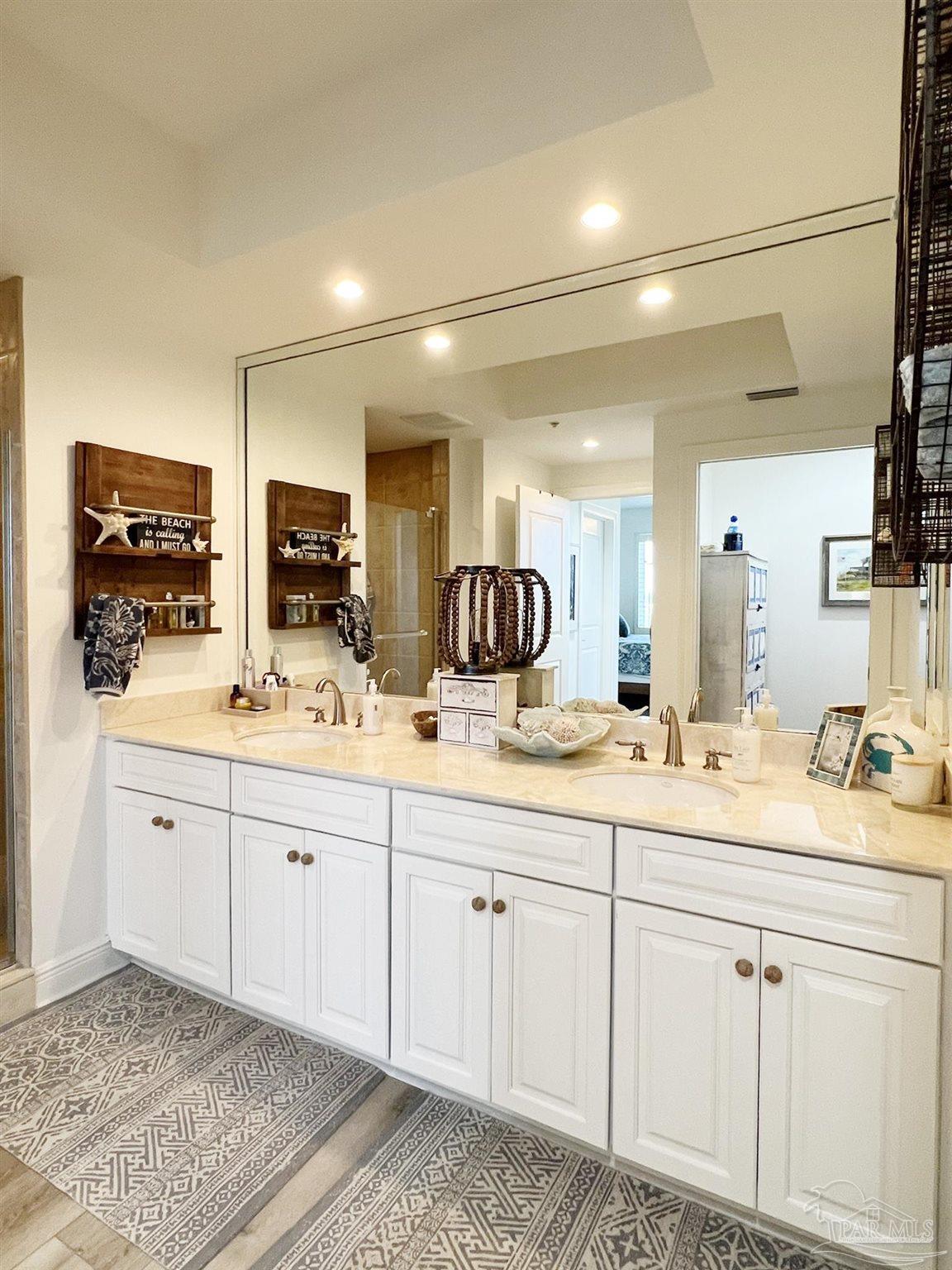 608 Lost Key Drive, Unit 404C Perdido Key, FL 32507 - Photo 10 of 28 a spacious bathroom with double sink and a mirror