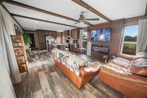 a living room with furniture a flat screen tv and a fireplace