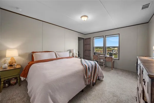 a bed room with a bed and a window