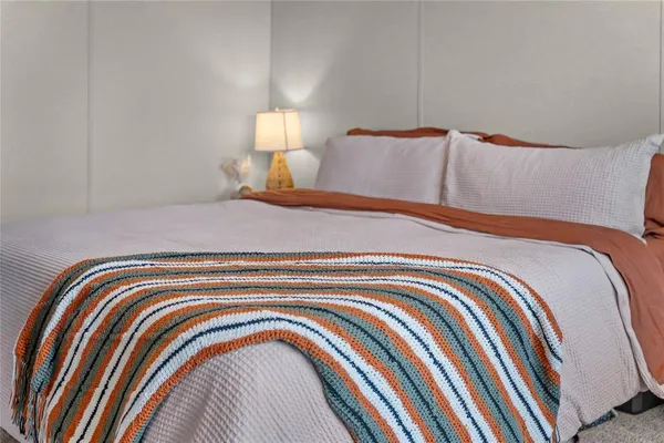 a bedroom with a bed and a night stand