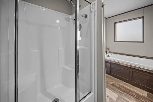 a bathroom with a shower and mirror