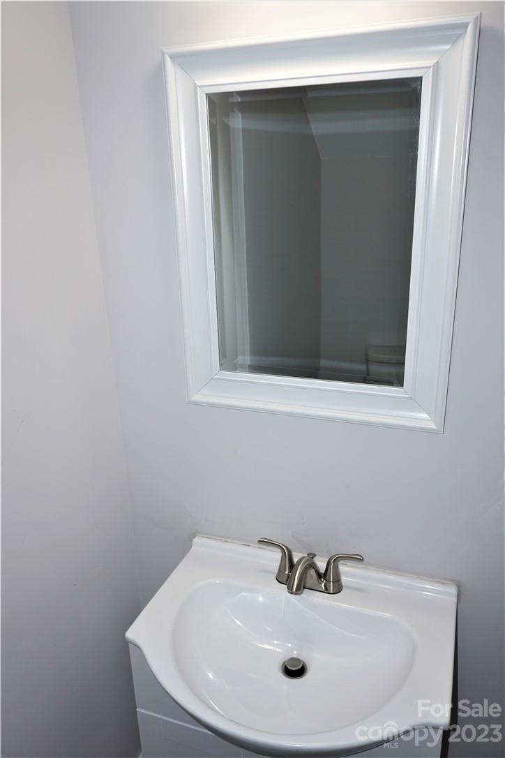 1048 McLain Road Kannapolis, NC 28083 - Photo 13 of 31 a bathroom with a sink and mirror