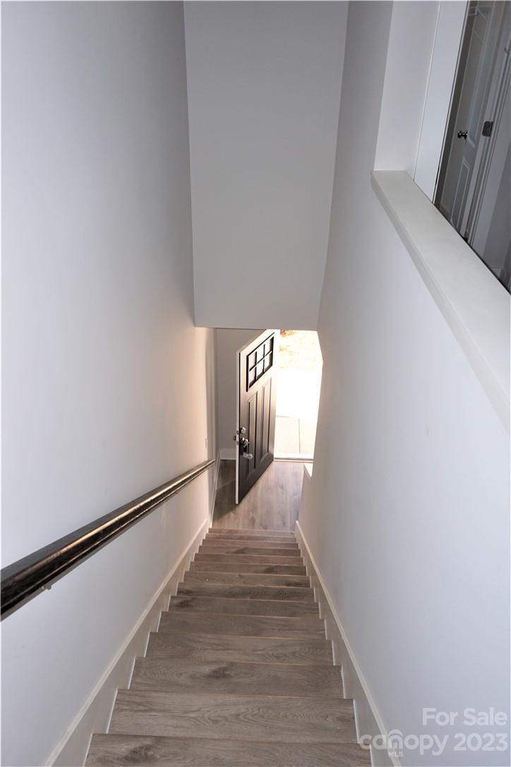 1048 McLain Road Kannapolis, NC 28083 - Photo 14 of 31 a view of a hallway with wooden floor and staircase