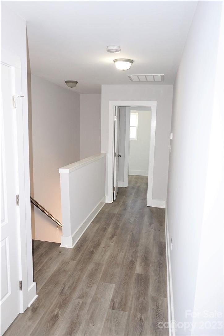 1048 McLain Road Kannapolis, NC 28083 - Photo 15 of 31 a view of a hallway with wooden floor