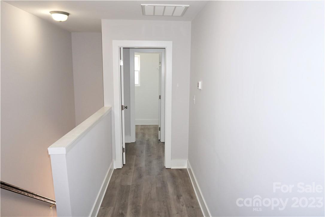 1048 McLain Road Kannapolis, NC 28083 - Photo 16 of 31 a view of a hallway with wooden floor