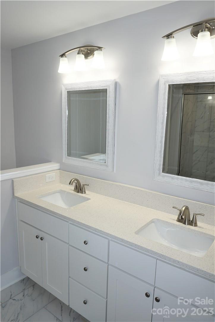 1048 McLain Road Kannapolis, NC 28083 - Photo 19 of 31 a bathroom with a sink and a mirror
