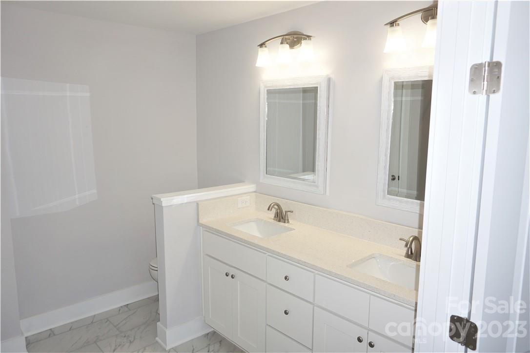 1048 McLain Road Kannapolis, NC 28083 - Photo 21 of 31 a bathroom with a granite countertop sink and a mirror