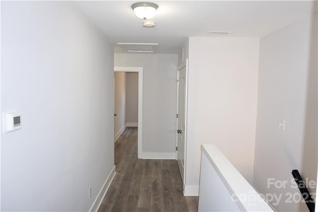 1048 McLain Road Kannapolis, NC 28083 - Photo 23 of 31 a view of a hallway with wooden floor