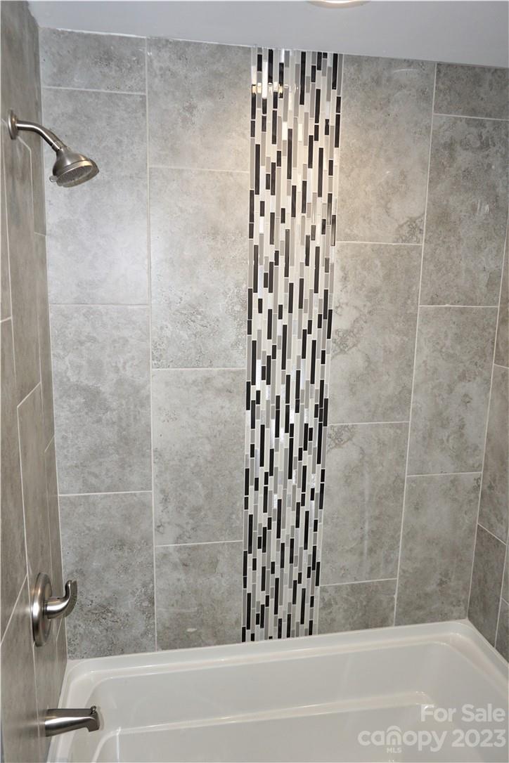 1048 McLain Road Kannapolis, NC 28083 - Photo 27 of 31 a bathroom with a shower and a glass door