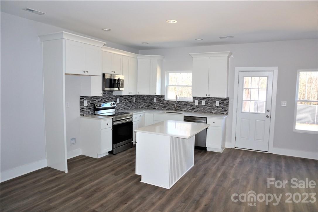 1048 McLain Road Kannapolis, NC 28083 - Photo 10 of 31 a kitchen with granite countertop a sink cabinets and wooden floor