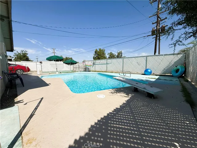 a view of a patio with table and chairs with the couches near an umbrella