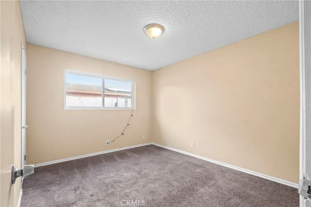 a view of a room with wooden floor and white walls
