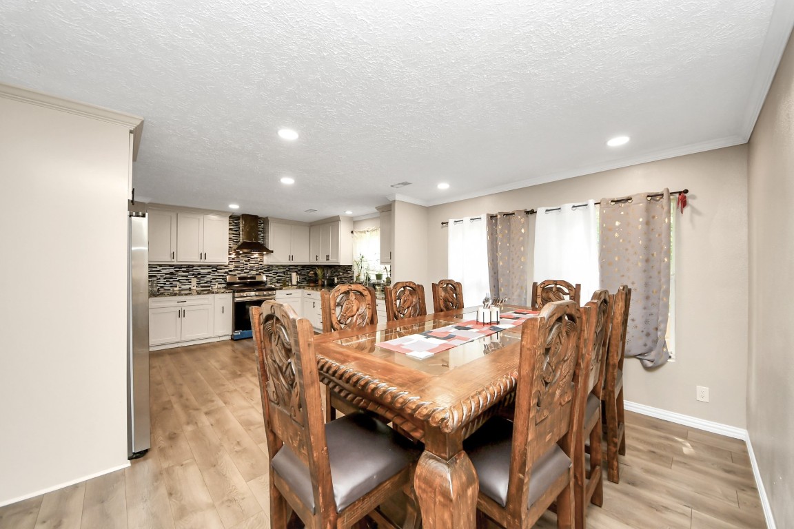 11844 Padok Road Houston, TX 77044 - Photo 15 of 41 a view of a dining room with furniture and wooden floor