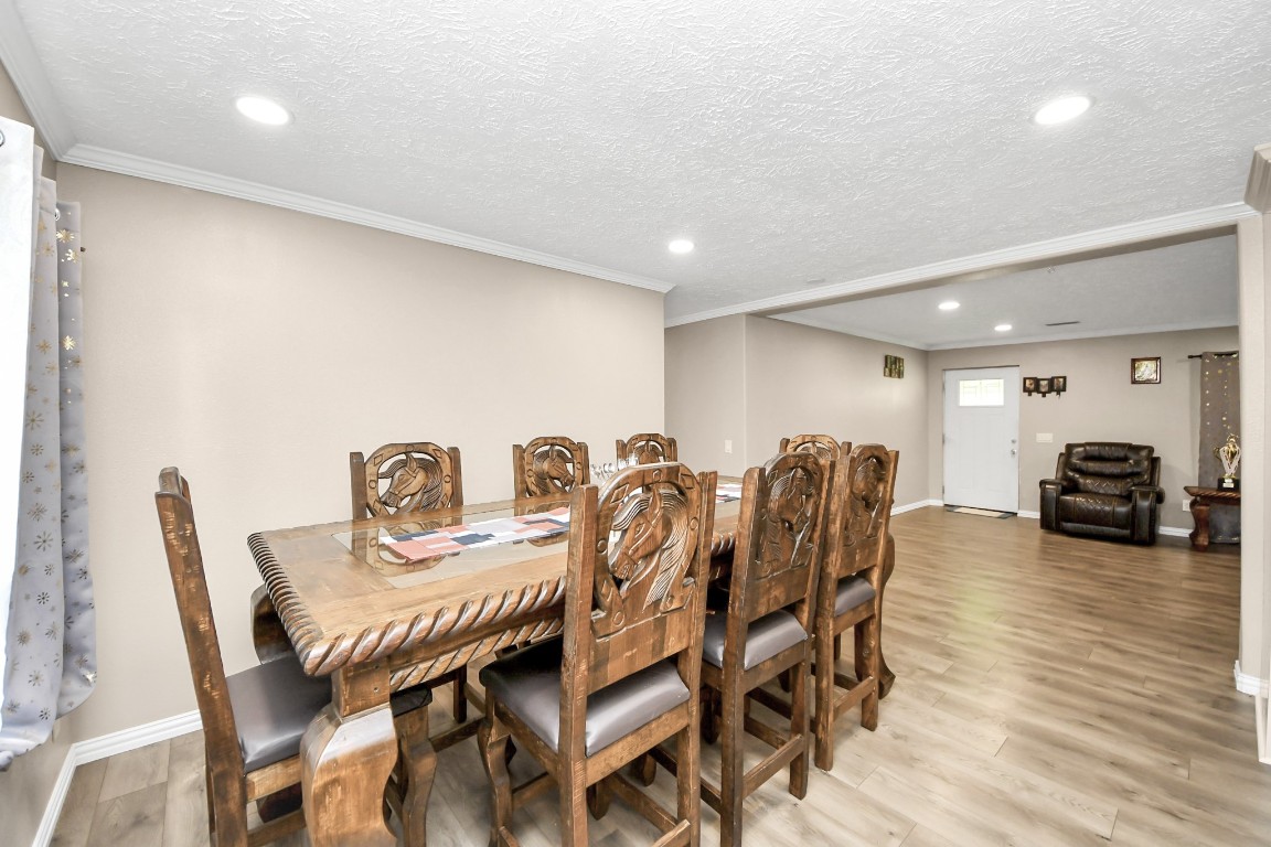 11844 Padok Road Houston, TX 77044 - Photo 16 of 41 a view of a dining room with furniture and wooden floor