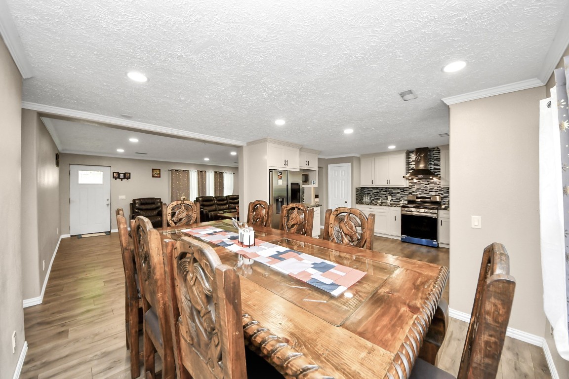 11844 Padok Road Houston, TX 77044 - Photo 17 of 41 a very nice looking kitchen with a dining table chairs and refrigerator