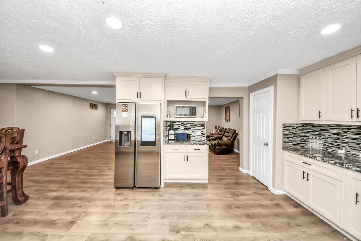 11844 Padok Road Houston, TX 77044 - Photo 23 of 41 a view of a kitchen with refrigerator and white cabinets
