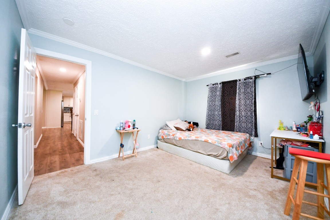 11844 Padok Road Houston, TX 77044 - Photo 36 of 41 a bed room with a bed and a flat screen tv