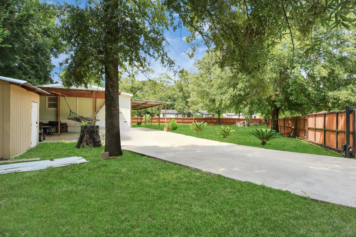 11844 Padok Road Houston, TX 77044 - Photo 7 of 41 a view of a park with large trees and a big yard
