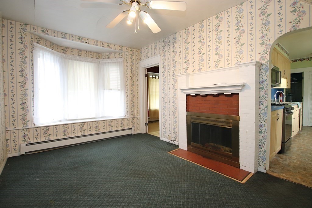 3 Linwood Street Saugus, MA 01906 - Photo 11 of 42 a view of empty room with fireplace and fan