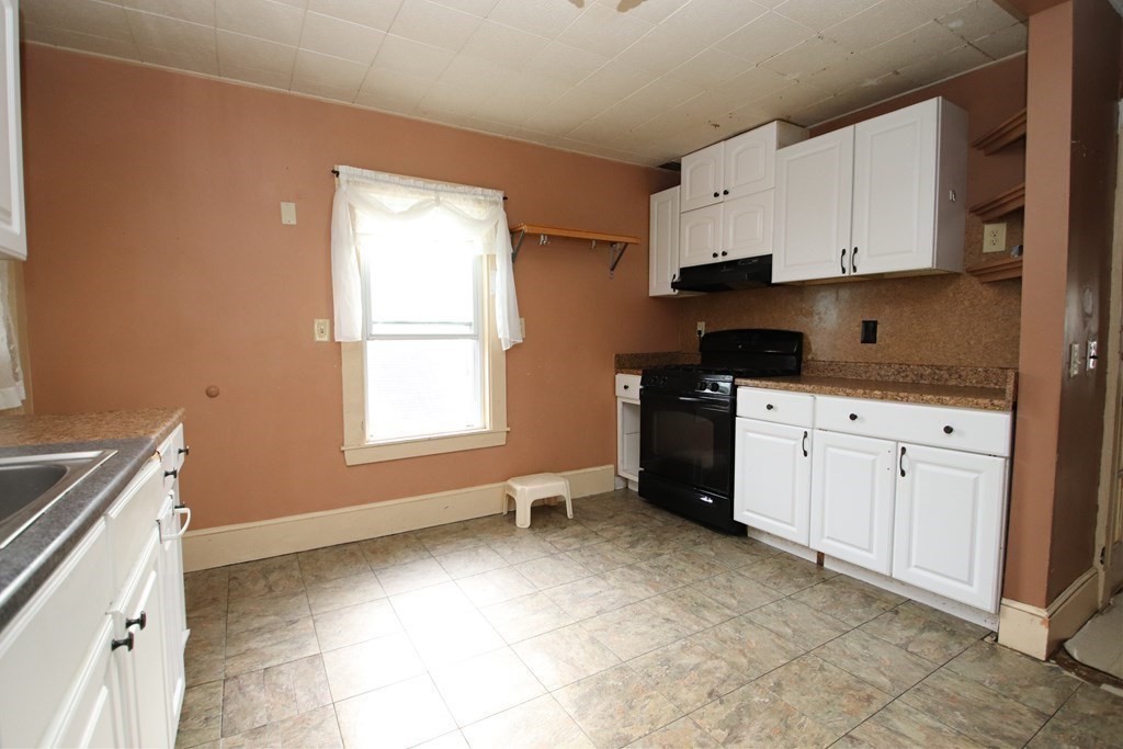 3 Linwood Street Saugus, MA 01906 - Photo 24 of 42 a kitchen with granite countertop white cabinets and white appliances