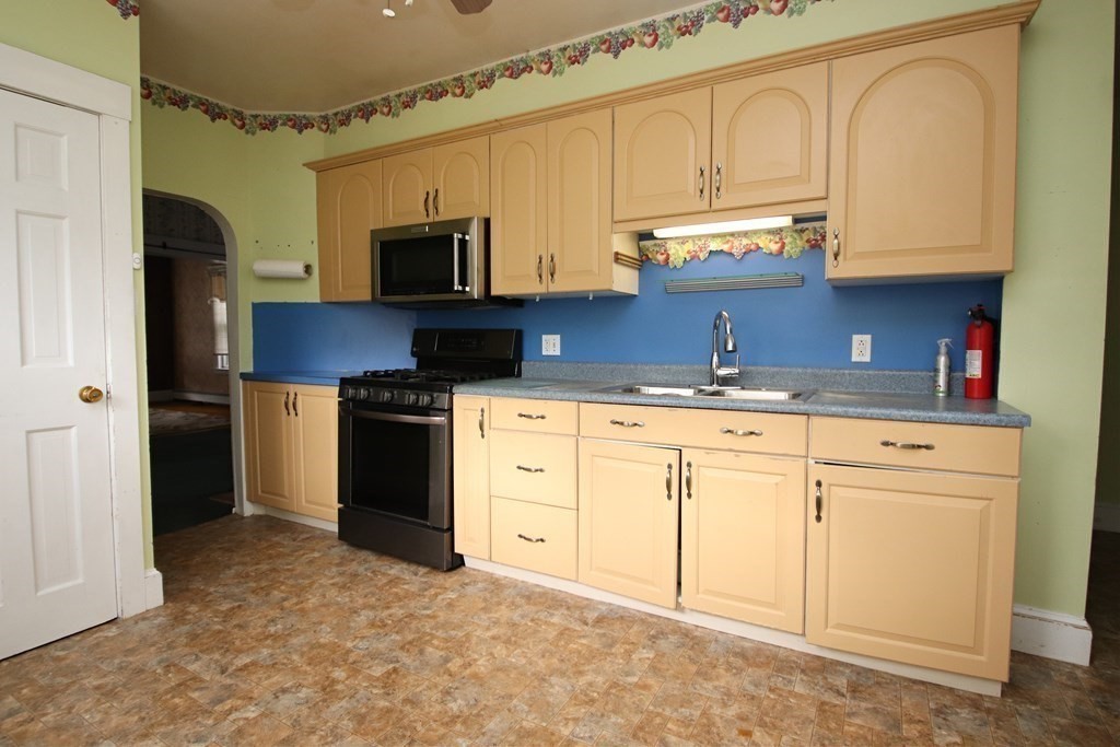 3 Linwood Street Saugus, MA 01906 - Photo 5 of 42 a kitchen with granite countertop a sink a stove and cabinets