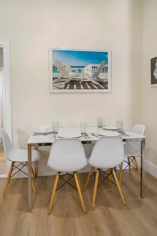 a view of a dining room with furniture and chandelier