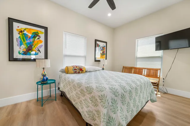 a bedroom with a bed and painting on the wall