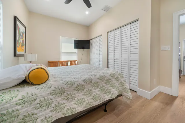 a bedroom with a bed and a chandelier