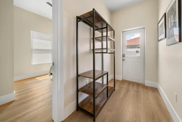 a view of entryway with wooden floor and stairs