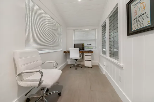 a room with a chair and white walls