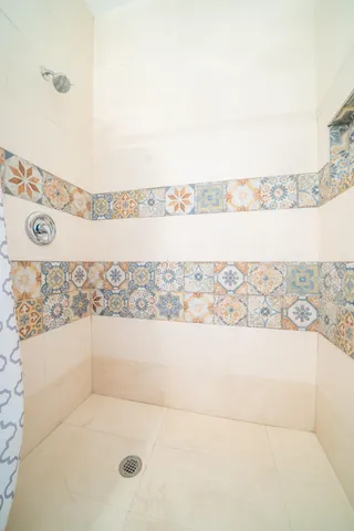 a bathroom with a bathtub and shower