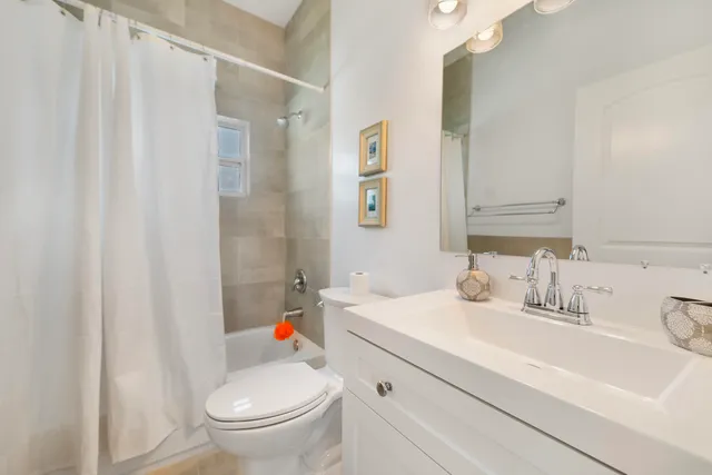 a bathroom with a sink a toilet and shower curtain
