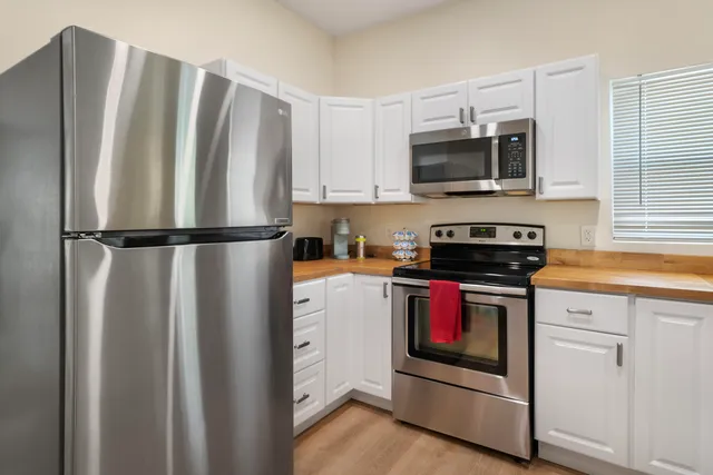 a kitchen with stainless steel appliances a refrigerator stove and microwave