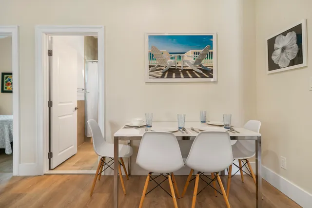 a view of a dining room with furniture and wooden floor