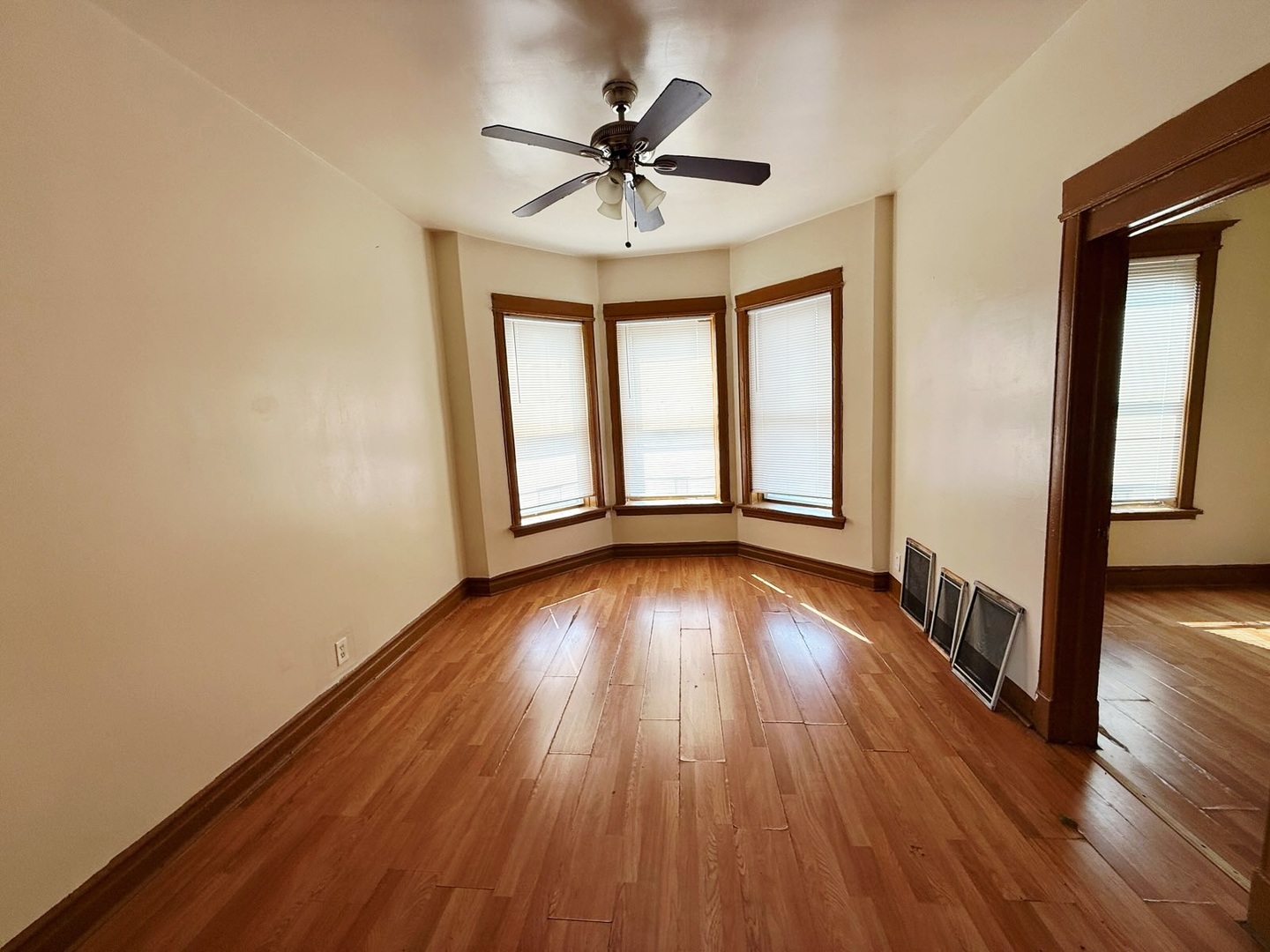 6643 South Laflin Street Chicago, IL 60636 - Photo 2 of 15 wooden floor in an empty room with a window