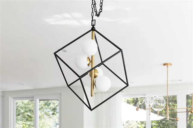 a front view of a house with a garden and trees