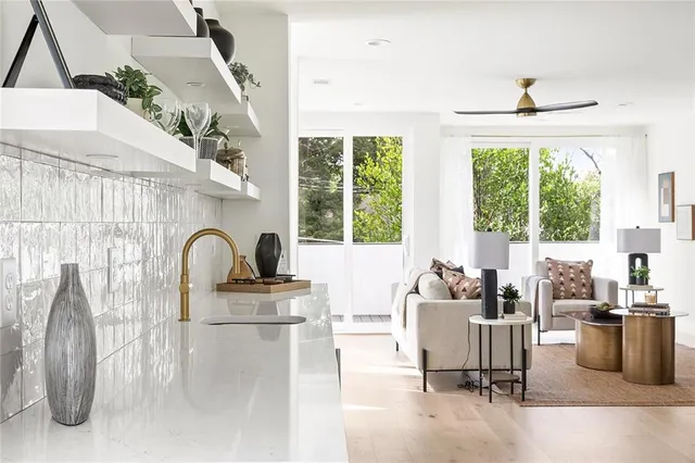 a living room with furniture and a potted plant