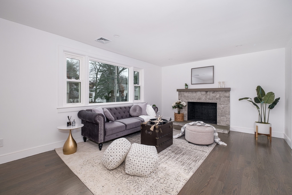 26 Harris Avenue Wellesley, MA 02481 - Photo 11 of 42 a living room with furniture and a fireplace