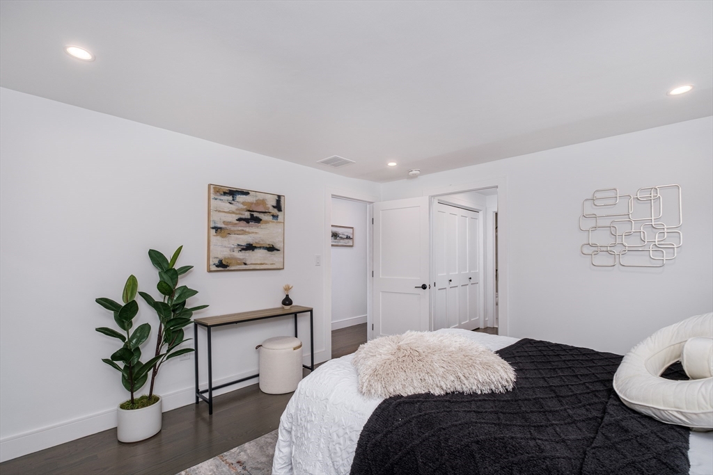 26 Harris Avenue Wellesley, MA 02481 - Photo 15 of 42 a bedroom with a bed and a potted plant