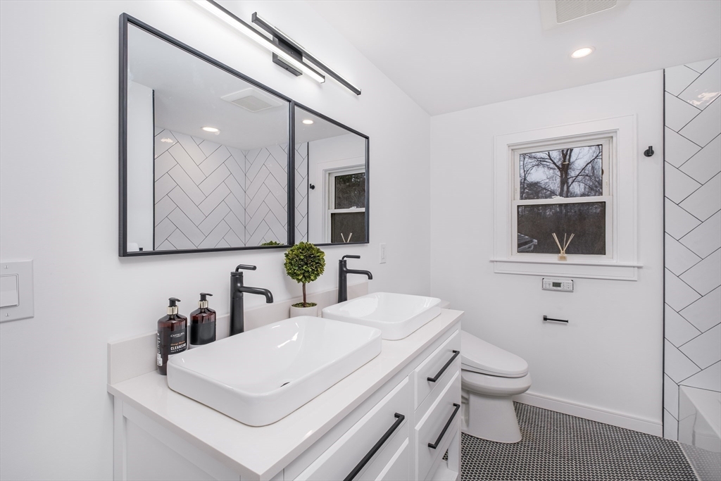 26 Harris Avenue Wellesley, MA 02481 - Photo 24 of 42 a bathroom with a toilet sink and mirror