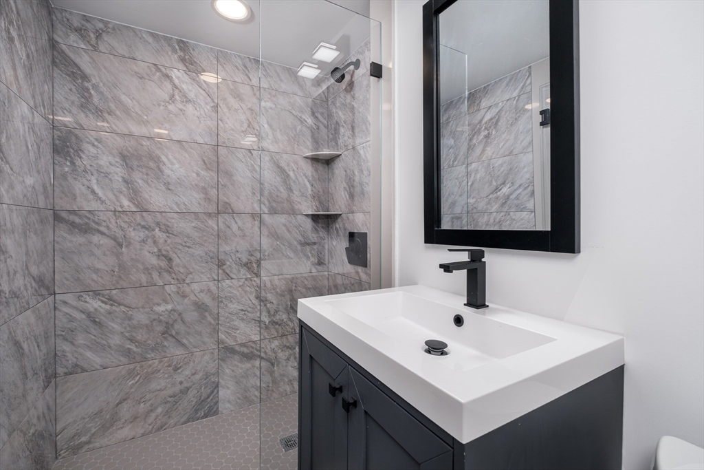26 Harris Avenue Wellesley, MA 02481 - Photo 28 of 42 a bathroom with a sink mirror and vanity
