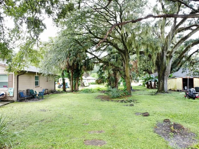 a view of a yard with a house in the background