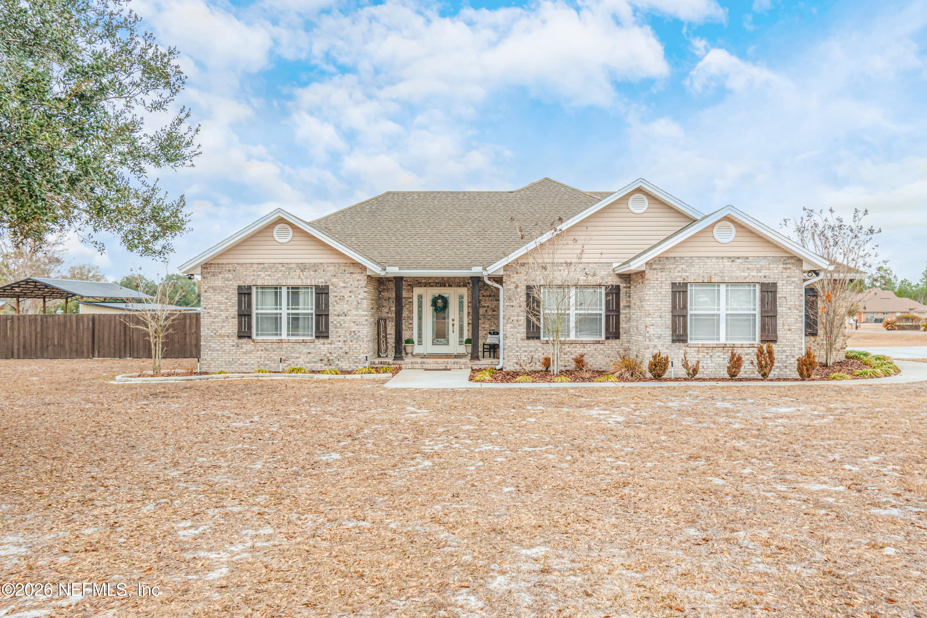 8139 Hunters Ridge South Glen St. Mary, FL 32040 - Photo 1 of 49 a front view of a house with a yard and porch