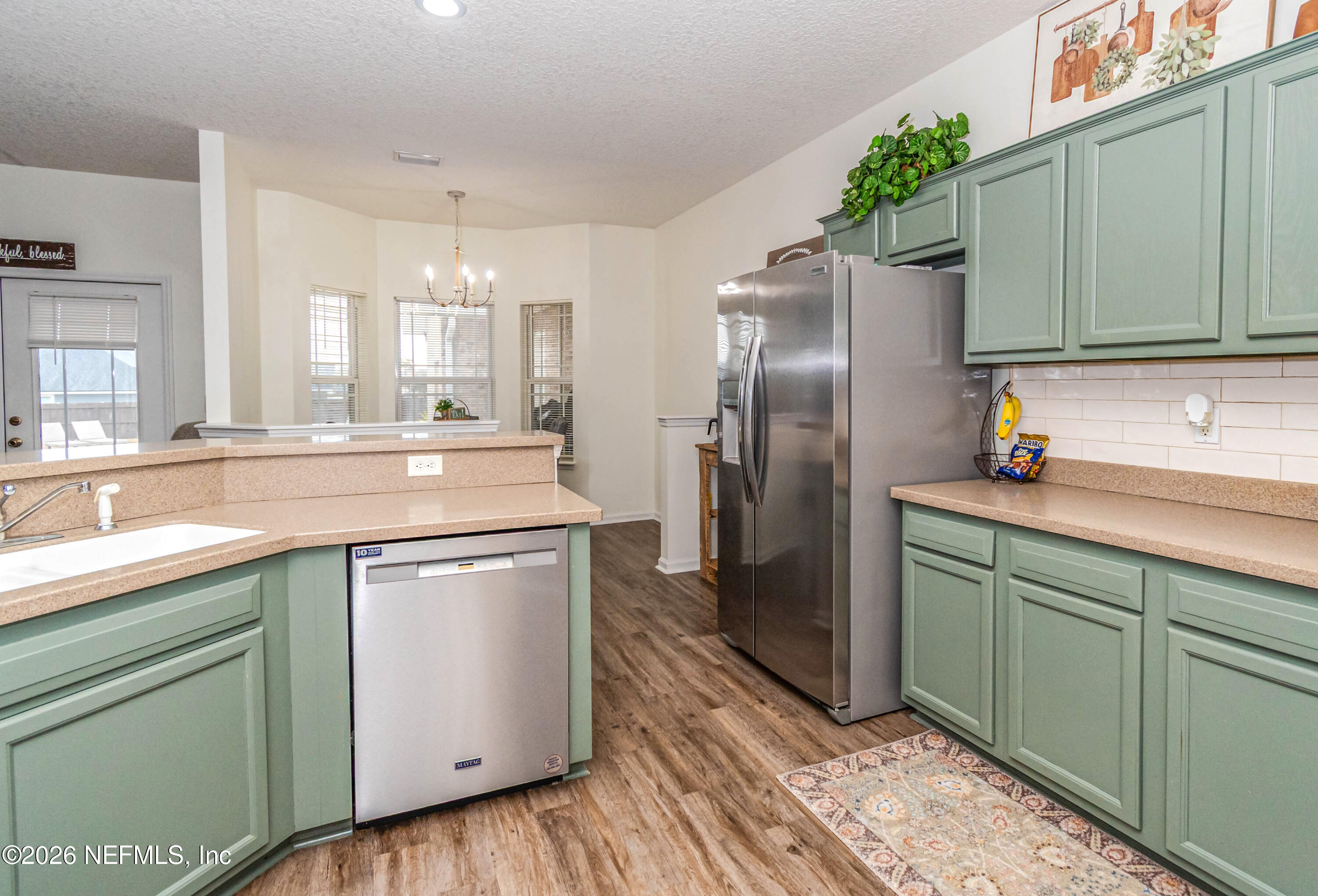 8139 Hunters Ridge South Glen St. Mary, FL 32040 - Photo 14 of 49 a kitchen with stainless steel appliances granite countertop a refrigerator sink and cabinets